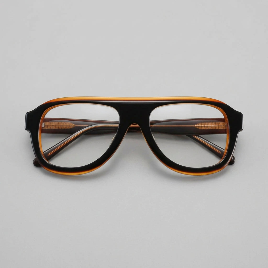 Black and orange eyeglasses on a dark surface with a black case.