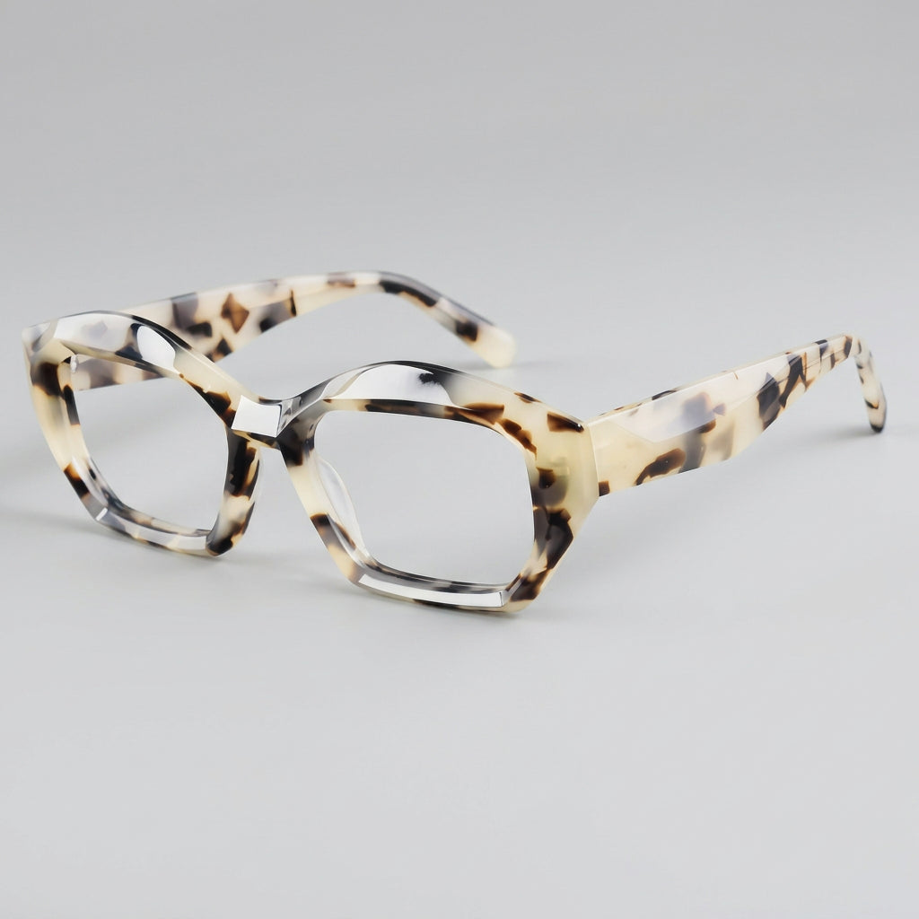 Tortoiseshell cat-eye glasses on a gray background