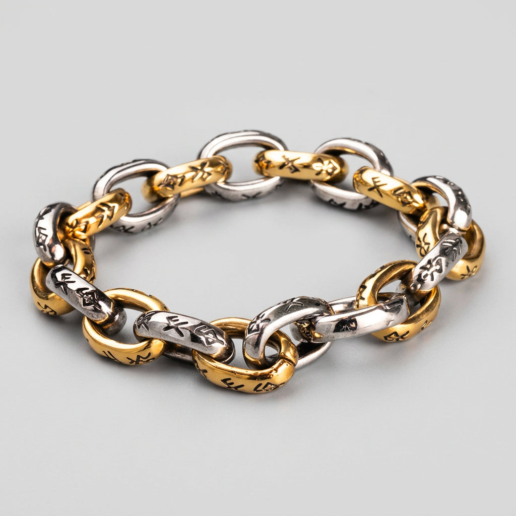 Gold and silver chain bracelet on a textured metal surface