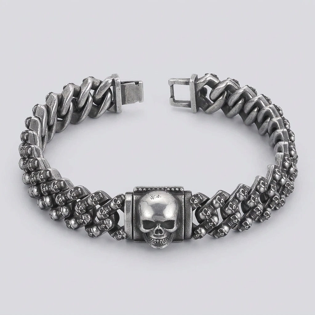 Silver chain bracelet with skull design on a black background